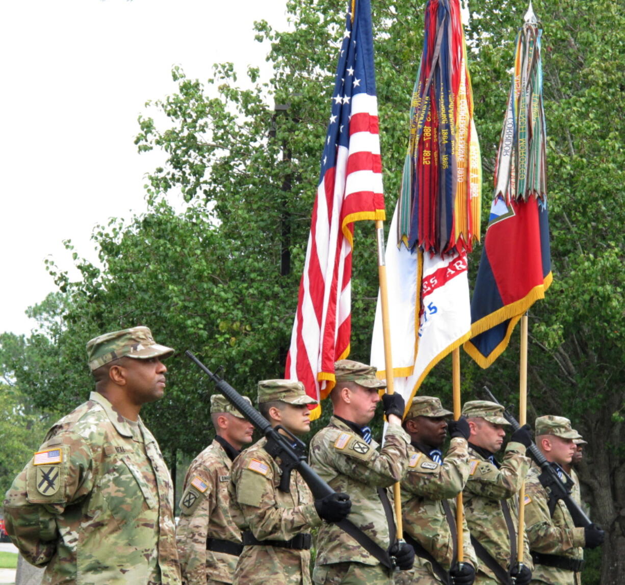 Col. Reginald Neal, far left, commander of the 48th Infantry Brigade of the Georgia National Guard, stands with an Army color guard Frida 2016 during a ceremony at Fort Stewart, Ga., to mark the brigade&#039;s new alignment with the Army&#039;s 3rd Infantry Division. The Army is pairing a dozen National Guard and Reserve units nationwide with active-duty commands, hoping to improve the combat readiness of citizen-soldiers.