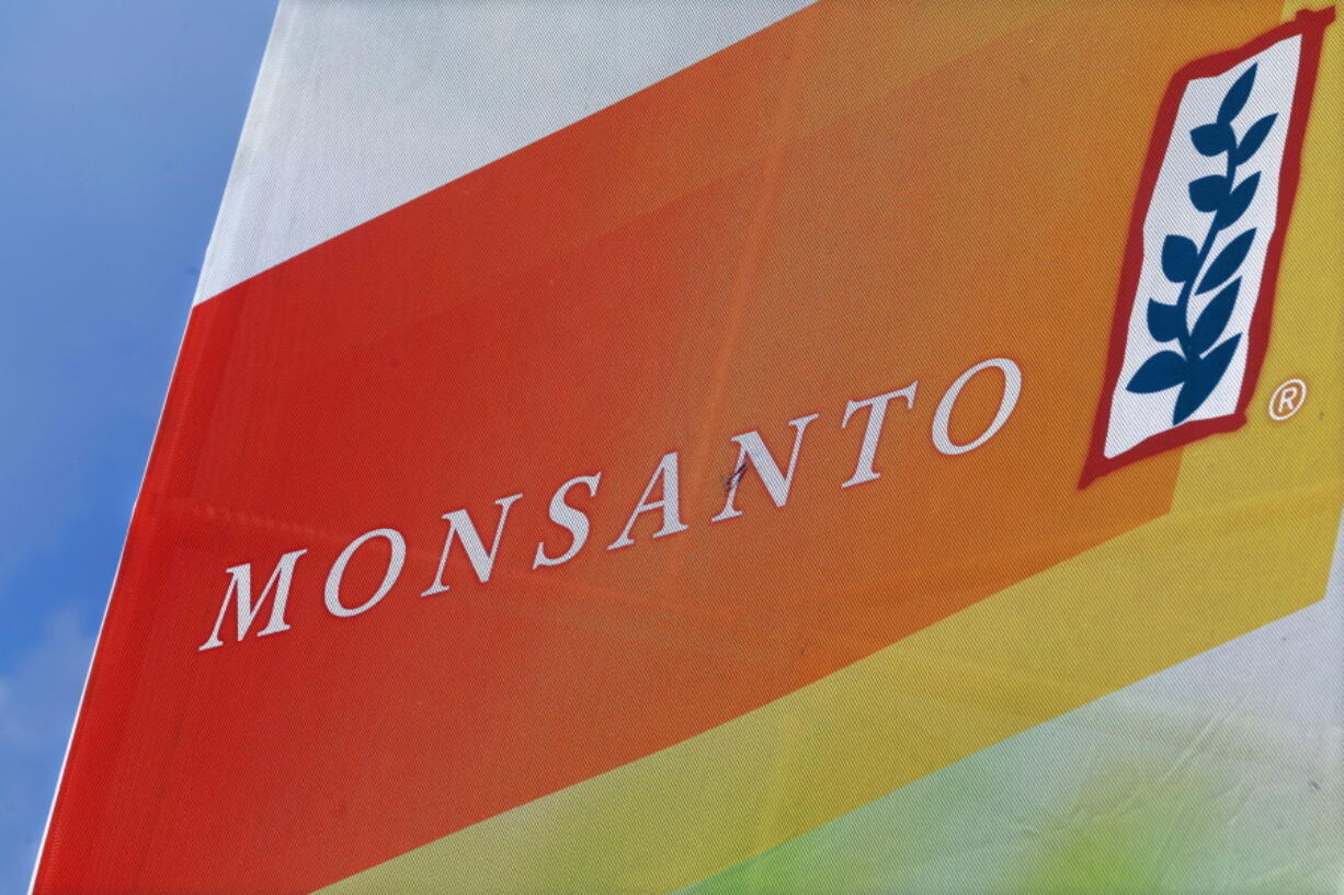 The Monsanto logo on display at the Farm Progress Show in Decatur, Ill. on Aug. 31, 2015. German drug and farm chemical company Bayer AG said it has signed a deal Wednesday, Sept. 14, 2016, to acquire seed and weed-killer company Monsanto for about $66 billion in cash.