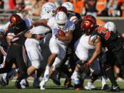 Boise State running back Jeremy McNichols, center, bulls his way through the Oregon State defense in the second half of an NCAA college football game in Corvallis, Ore., on Saturday, Sept. 24, 2016. Boise State won 38-24. (AP Photo/Timothy J.