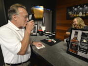 Scott Schwar, left, of Oak Park, Il, orders the first cocktail from Stacy Clark at the new Jim Beam Bourbon Bar located on the grounds of the Jim Beam Distillery, Wednesday, Sep. 14, 2016, in Clermont, Ky. This summer, Kentucky passed legislation allowing distilleries to apply for licences to permit the sale of cocktails by the glass, and Jim Beam was among the first to receive it&#039;s license. (AP Photo/Timothy D. Easley) (Timothy D.