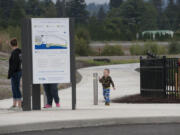 Aspen Matthews of Washougal, left, joins family member Jackson Fetter, 3, on the new walking trail near the Port of Camas-Washougal on Thursday morning.