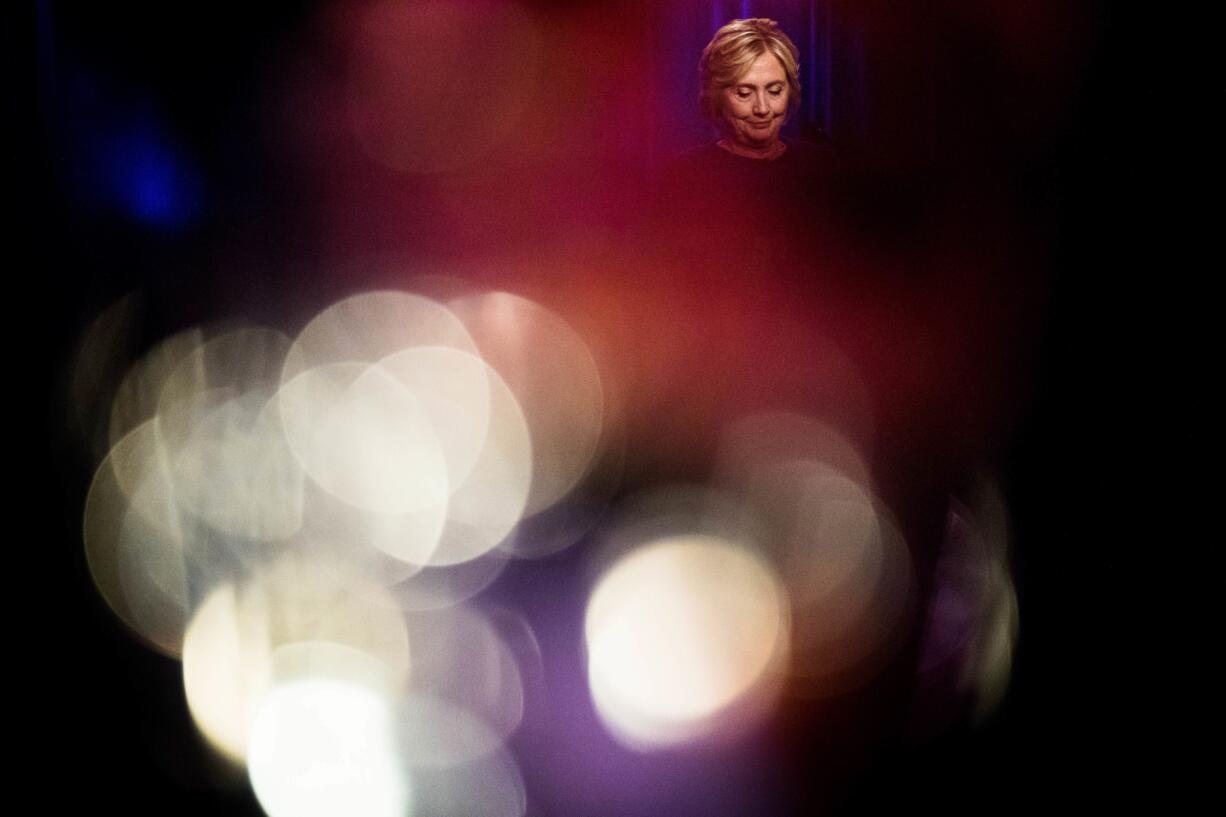 Democratic presidential candidate Hillary Clinton, seen through candles, pauses while speaking at a LBGT For Hillary Gala at the Cipriani Club, in New York, Friday, Sept. 9, 2016.