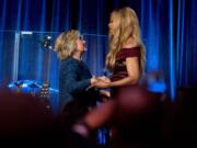 Democratic presidential candidate Hillary Clinton, left, is welcomed to the stage by Laverne Cox, right, at a LBGT For Hillary Gala at the Cipriani Club, in New York, Friday, Sept. 9, 2016.