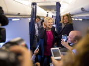 Democratic presidential candidate Hillary Clinton, accompanied by traveling press secretary Nick Merrill, left, and director of communications Jennifer Palmieri, right, listens to a question from a member of the media as her campaign plane prepares to take off at Westchester County Airport in Westchester, N.Y., on Tuesday to head to Tampa for a rally in Tampa.