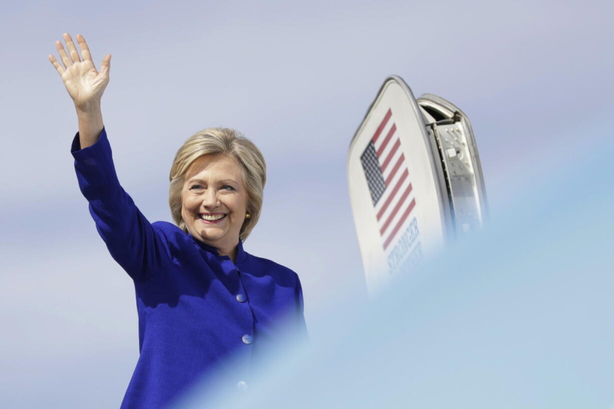 Democratic presidential candidate Hillary Clinton waves as she boards her campaign plane at Westchester County Airport in White Plains, N.Y., on Wednesday.