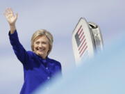 Democratic presidential candidate Hillary Clinton waves as she boards her campaign plane at Westchester County Airport in White Plains, N.Y., on Wednesday.