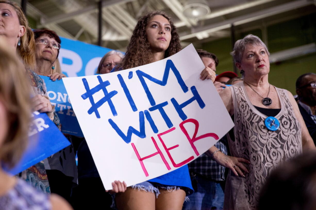 A supporter holds an &quot;#I&#039;m With Her&quot; sign as Democratic presidential candidate Hillary Clinton speaks Tuesday at a rally at University of South Florida in Tampa, Fla.