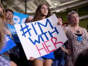 A supporter holds an &quot;#I&#039;m With Her&quot; sign as Democratic presidential candidate Hillary Clinton speaks Tuesday at a rally at University of South Florida in Tampa, Fla.