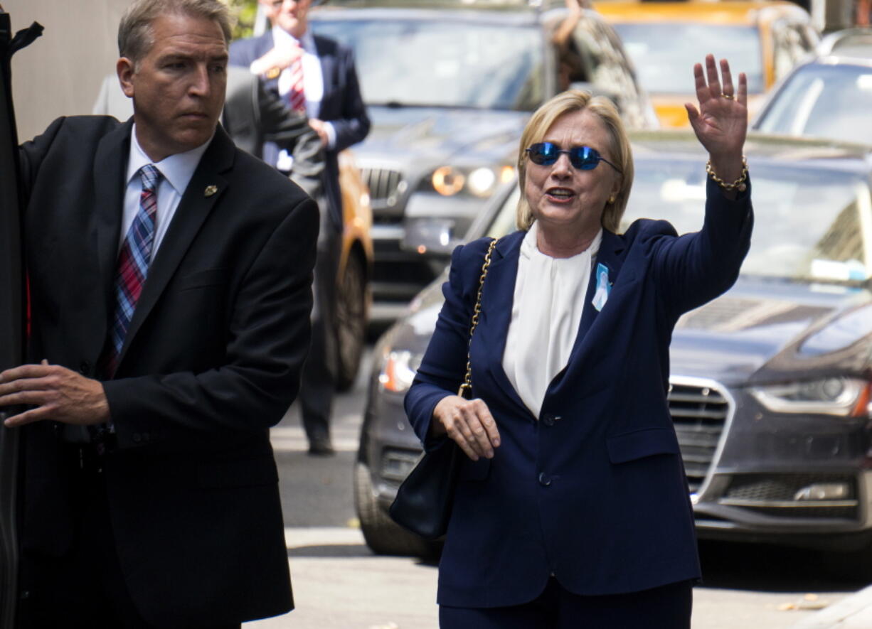 Democratic presidential candidate Hillary Clinton walks from her daughter&#039;s apartment building Sunday in New York. Clinton unexpectedly left Sunday&#039;s 9/11 anniversary ceremony in New York after feeling &quot;overheated,&quot; according to her campaign.