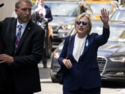 Democratic presidential candidate Hillary Clinton walks from her daughter&#039;s apartment building Sunday in New York. Clinton unexpectedly left Sunday&#039;s 9/11 anniversary ceremony in New York after feeling &quot;overheated,&quot; according to her campaign.