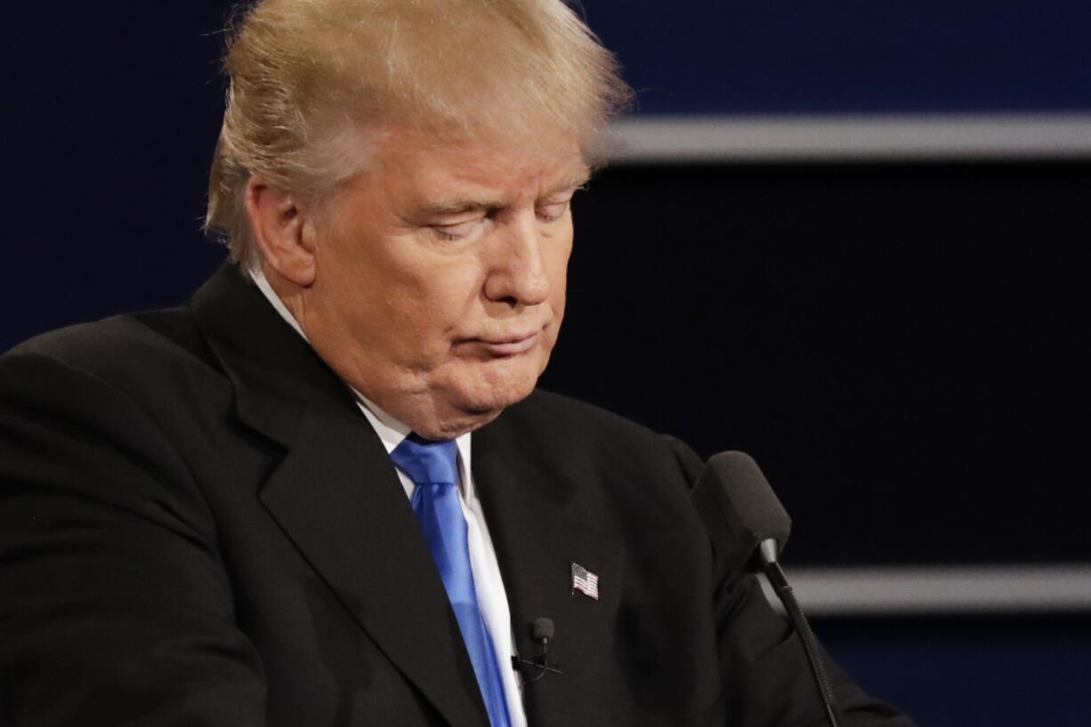 Republican presidential nominee Donald Trump listens to an answer to a question from Democratic presidential nominee Hillary Clinton during the presidential debate at Hofstra University in Hempstead, N.Y., on Monday.