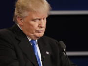 Republican presidential nominee Donald Trump listens to an answer to a question from Democratic presidential nominee Hillary Clinton during the presidential debate at Hofstra University in Hempstead, N.Y., on Monday.