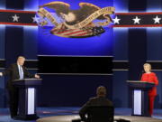 Republican presidential nominee Donald Trump answers a question as Democratic presidential nominee Hillary Clinton listens during the presidential debate at Hofstra University in Hempstead, N.Y., on Monday.