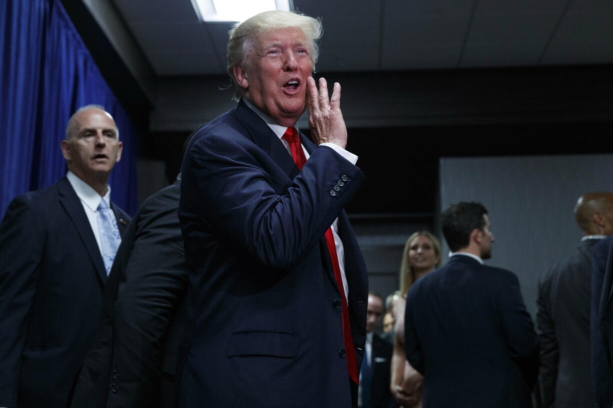 Republican presidential candidate Donald Trump talks to supporters in an overflow room during a campaign rally, Tuesday in Greenville, N.C.