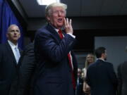 Republican presidential candidate Donald Trump talks to supporters in an overflow room during a campaign rally, Tuesday in Greenville, N.C.