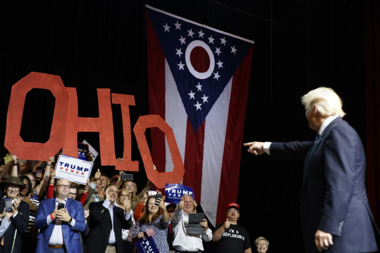 Supporters of  Republlican presidential candidate Donald Trump cheer as he arrives at a rally Wednesday in Canton, Ohio.