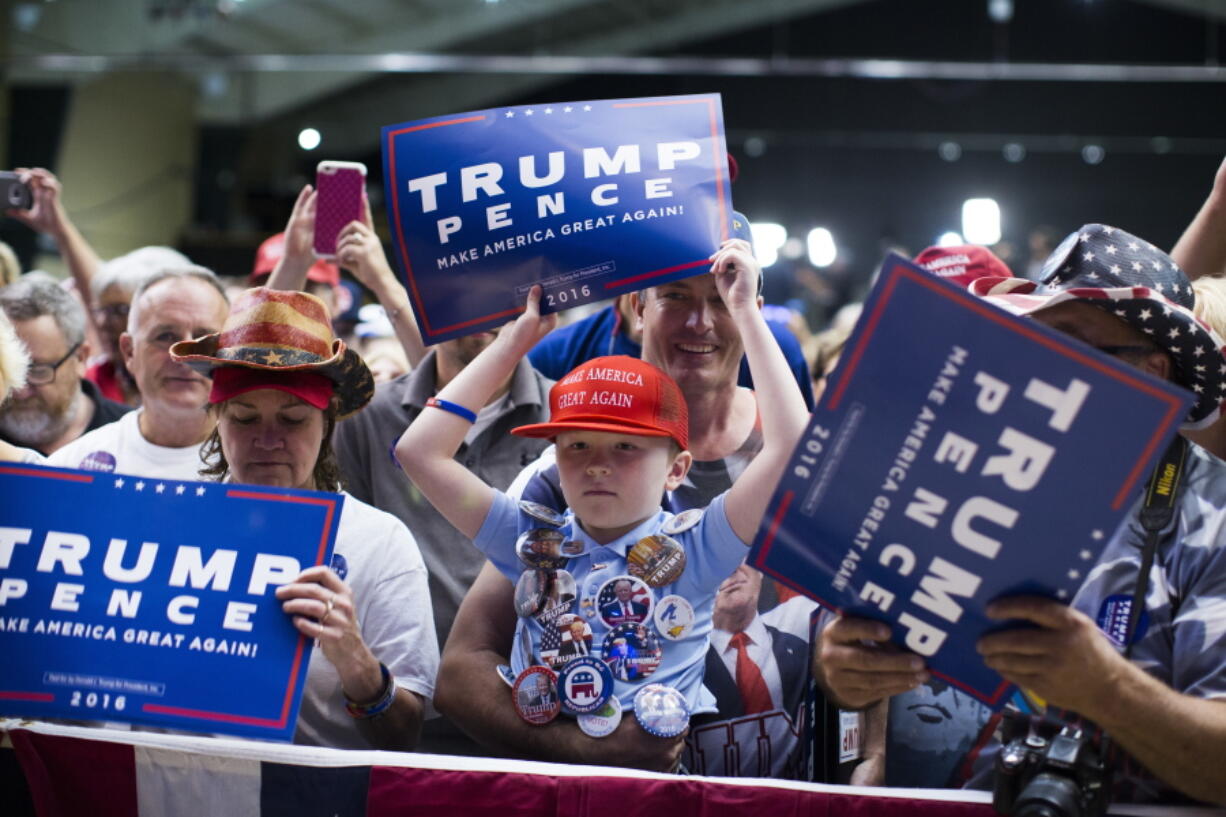 Mason Halliburton, 7, of Omaha, Neb., waits for the arrival of Republican presidential candidate Donald Trump to a campaign rally, Tuesday in Clive, Iowa.