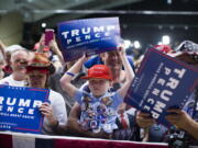 Mason Halliburton, 7, of Omaha, Neb., waits for the arrival of Republican presidential candidate Donald Trump to a campaign rally, Tuesday in Clive, Iowa.