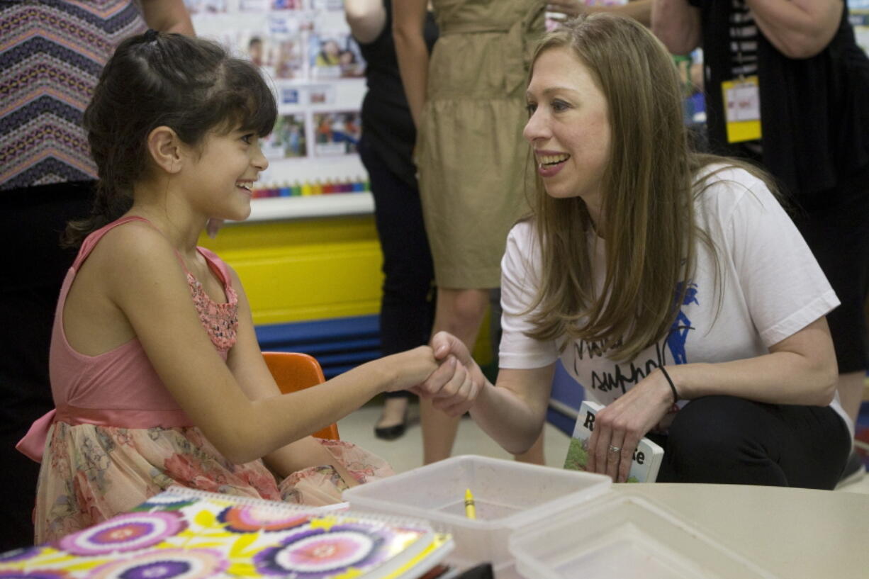 Chelsea Clinton, the daughter of Democratic presidential candidate Hillary Clinton, right, shakes hands with Marie Vazquez-Miller, at Small Steps Learning Academy, in Roanoke, Va., on Wednesday, Sept. 14, 2016.