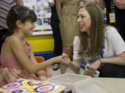 Chelsea Clinton, the daughter of Democratic presidential candidate Hillary Clinton, right, shakes hands with Marie Vazquez-Miller, at Small Steps Learning Academy, in Roanoke, Va., on Wednesday, Sept. 14, 2016.