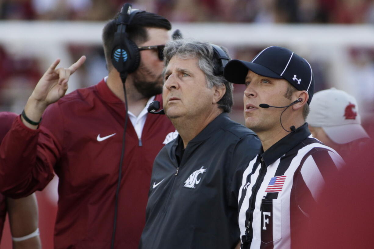 Washington State head coach Mike Leach, center, watches a replay during the first half of an NCAA college football game against the Eastern Washington in Pullman, Wash., Saturday, Sept. 3, 2016.