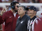 Washington State head coach Mike Leach, center, watches a replay during the first half of an NCAA college football game against the Eastern Washington in Pullman, Wash., Saturday, Sept. 3, 2016.