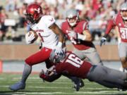 Eastern Washington wide receiver Shaq Hill (1) runs the ball against Washington State defensive back Treshon Broughton (16) during the first half of an NCAA college football game in Pullman, Wash., Saturday, Sept. 3, 2016.