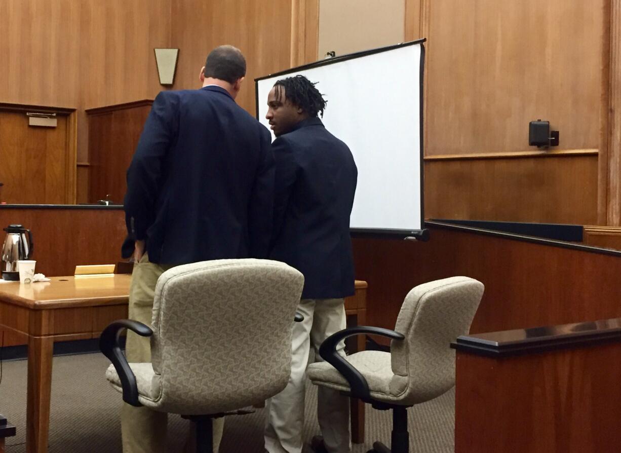 Timar Degraffe speaks with his attorney, Jack Peterson, on Thursday as he waits to hear the jury's verdict in his attempted-murder trial in Clark County Superior Court. Jurors found Degraffe guilty of robbing a Vancouver iQ Credit Union and assaulting a customer by stabbing him when he tried to intervene. They were unable to reach a verdict on the attempted murder charge.