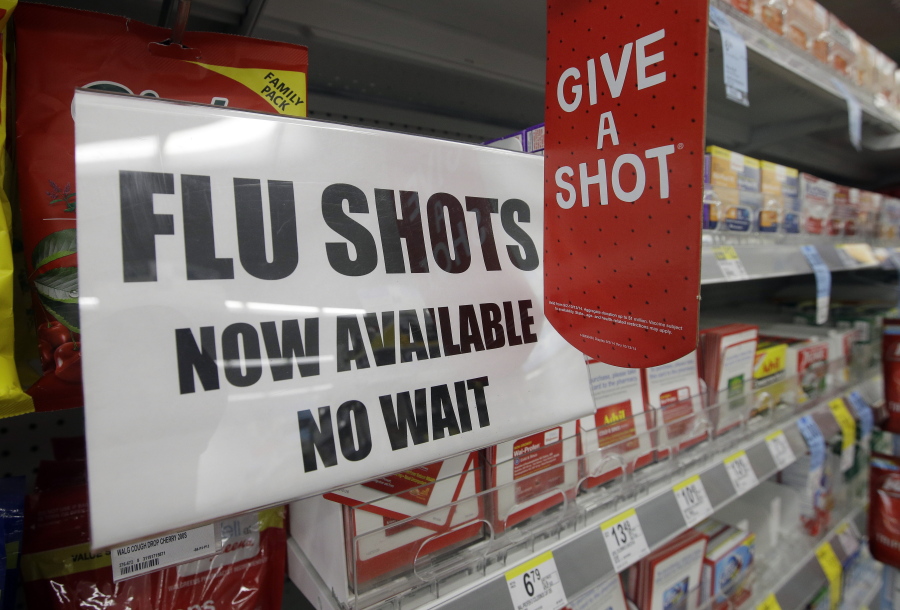 A sign tells customers that they can get a flu shot in a Walgreen store in Indianapolis.