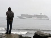 A man stands Aug. 21 on the Bering Sea shore looking at the luxury cruise ship Crystal Serenity anchored just outside Nome, Alaska. The ship made a port call as it became the largest cruise ship to ever go through the Northwest Passage, en route to New York City.