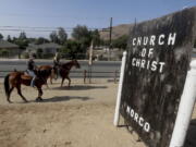 Women on horseback ride in Norco, Calif. The Southern California city has rejected plans for a proposed Hindu cultural center partly because officials say the large, domed building doesn&#039;t fit in with its Old West motif.