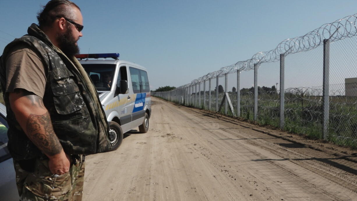 Ranger Zsolt Takacs guards the fence at Hungary&#039;s border with Serbia on Wednesday. It was built last year to stop migrants and refugees from entering the country. Hungary is planning to reinforce the barrier.