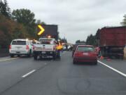 Police respond Tuesday to a three-vehicle crash on state Highway 14 in Vancouver. A Portland driver is suspected of striking a dump truck that was legally parked along the highway, then hitting another vehicle, according to the Washington State Patrol.