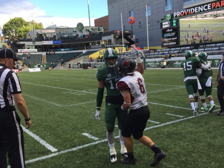 Central Washington receiver Jesse Zalk, a Prairie High School graduate, is congratulated by Portland State's Walter Santiago after a play Saturday at Providence Park in Portland.