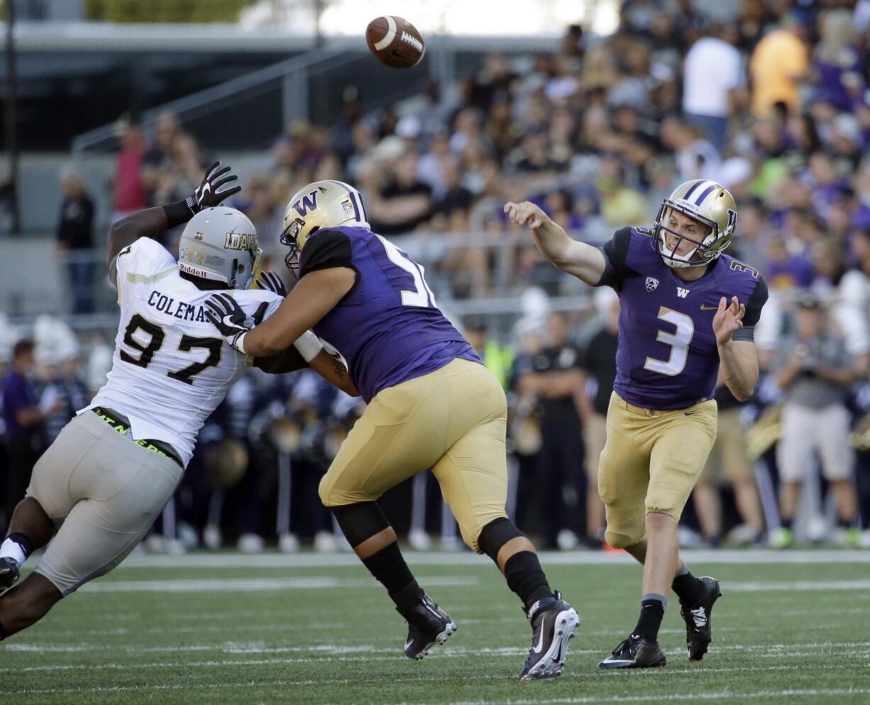 Washington quarterback Jake Browning (3) passes as Idaho defensive end Aikeem Coleman, left, is blocked by Washington offensive lineman Nick Harris, center, in the first half of an NCAA college football game, Saturday, Sept. 10, 2016, in Seattle. (AP Photo/Ted S.