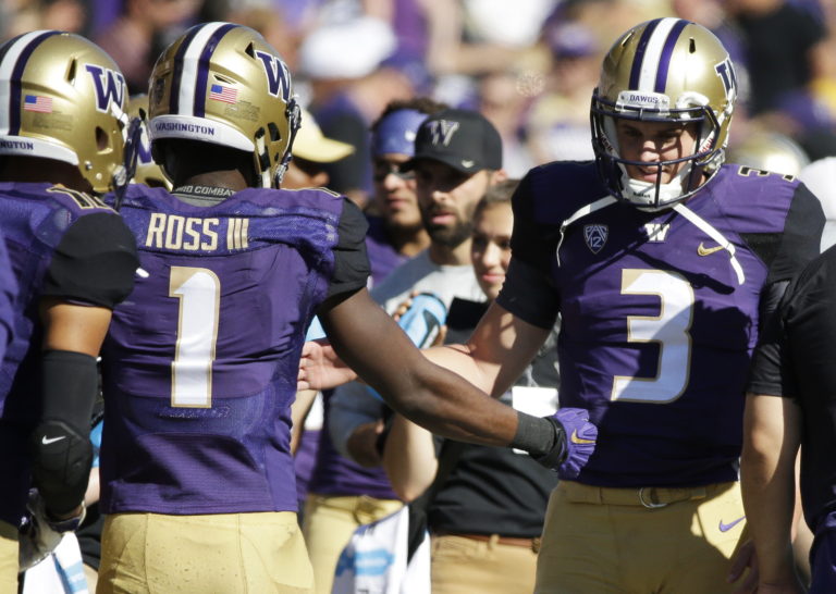 Washington quarterback Jake Browning (3) greets wide receiver John Ross (1) on the sideline after Ross scored a touchdown on a pass from Browning against Idaho in the first half of an NCAA college football game, Saturday, Sept. 10, 2016, in Seattle. (AP Photo/Ted S.