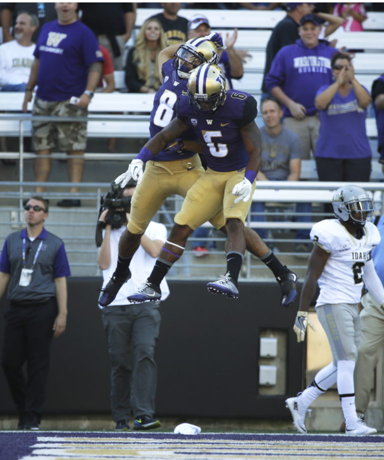 Washington wide receiver Dante Pettis (8) celebrates with wide receiver Chico McClatcher (6) after Pettis caught a pass for a touchdown against Idaho in the first half of an NCAA college football game, Saturday, Sept. 10, 2016, in Seattle. (AP Photo/Ted S.