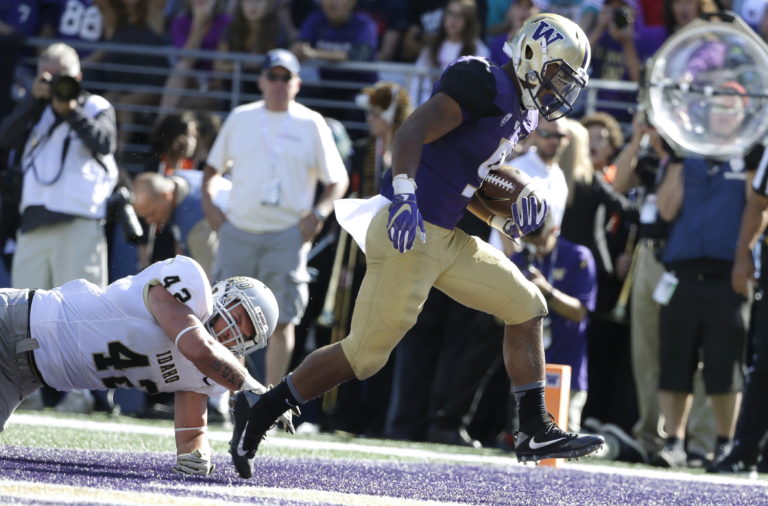 Washington running back Myles Gaskin, right, escapes a tackle attempt from Idaho linebacker Jason Sylva, left, to score a touchdown in the first half of an NCAA college football game, Saturday, Sept. 10, 2016, in Seattle. (AP Photo/Ted S.