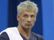 United States&#039; Ryan Lochte prepares before a men&#039;s 4x200-meter freestyle heat at the 2016 Summer Olympics, in Rio de Janeiro, Brazil, on Aug. 9. Lochte is banned from swimming through next June and will forfeit $100,000 in bonus money that went with his gold medal at the Olympics, part of the penalty for his drunken encounter at a gas station in Brazil during last month&#039;s games. The U.S. Olympic Committee and USA Swimming announced the penalties Thursday. Sept. 8, 2016.