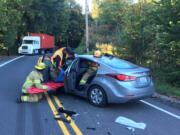 Firefighters extricated a 26-year-old woman after a head-on crash between a dump truck and a vehicle Wednesday morning. Timmen Road south of La Center is blocked in the area.