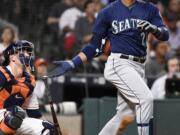 Seattle Mariners' Robinson Cano watches his solo home run off Houston Astros starting pitcher Collin McHugh during the third inning of a baseball game, Monday, Sept. 26, 2016, in Houston.