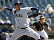 Seattle Mariners starting pitcher Felix Hernandez throws to the Oakland Athletics during the first inning of a baseball game, Saturday, Sept. 10, 2016, in Oakland, Calif.