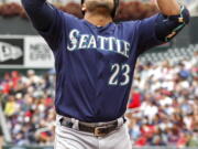 Seattle Mariners designated hitter Nelson Cruz celebrates his home run against the Minnesota Twins in the second inning of a baseball game Sunday, Sept. 25, 2016, in Minneapolis.