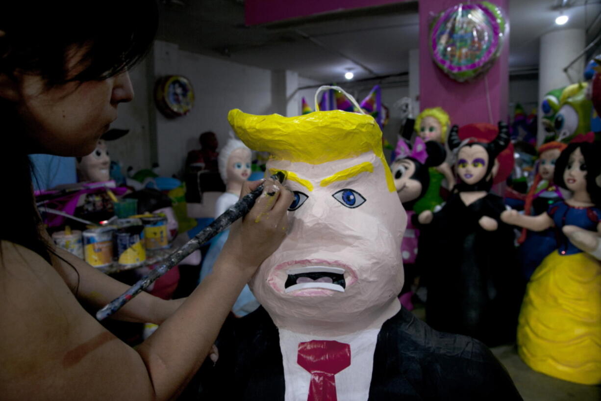 Alicia Lopez Fernandez paints a pinata depicting Donald Trump at her family&#039;s store &quot;Pinatas Mena Banbolinos&quot; in Mexico City.