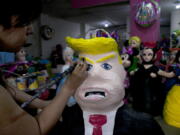 Alicia Lopez Fernandez paints a pinata depicting Donald Trump at her family&#039;s store &quot;Pinatas Mena Banbolinos&quot; in Mexico City.