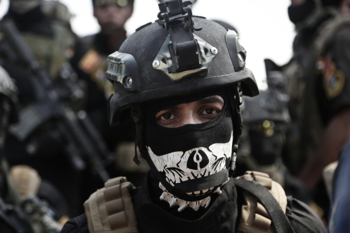 In this Saturday, Aug. 13, 2016 file photo, a soldier from the 1st Battalion of the Iraqi Special Operations Forces listens to an address by his commander after a training exercise to prepare for the operation to re-take Mosul from Islamic State militants, in Baghdad, Iraq. The disparate groups that make up Iraq&#039;s security forces are converging on the city of Mosul, lining up for a battle on the historic plains of northern Iraq that is likely to be decisive in the war against the Islamic State group.