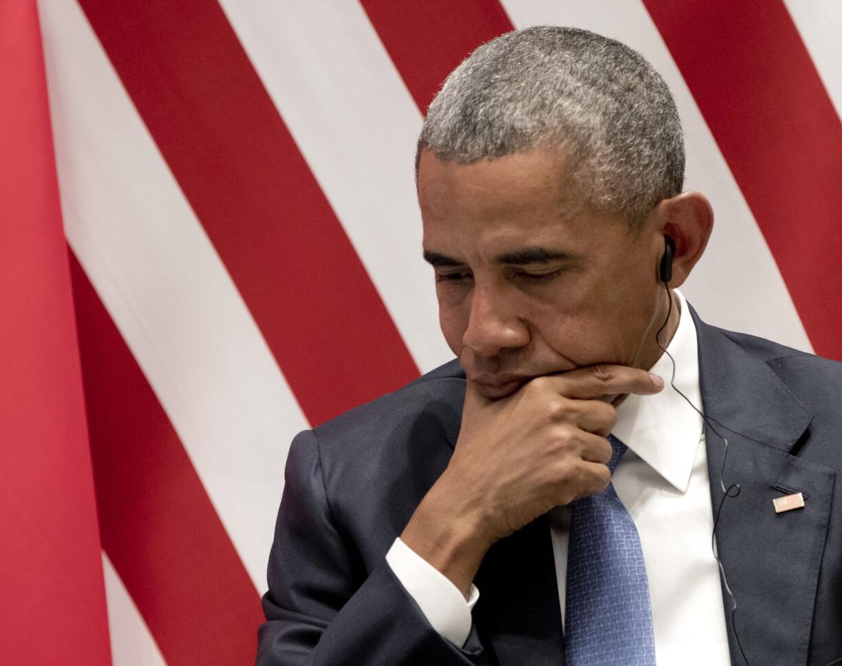 U.S. President Barack Obama listens to translation as he sits on stage during a climate change event with Chinese President Xi Jinping and U.N. Secretary-General Ban Ki-moon at the Ruyi Hall at West Lake State Guest House in Hangzhou in eastern China's Zhejiang province, Saturday, Sept. 3, 2016.