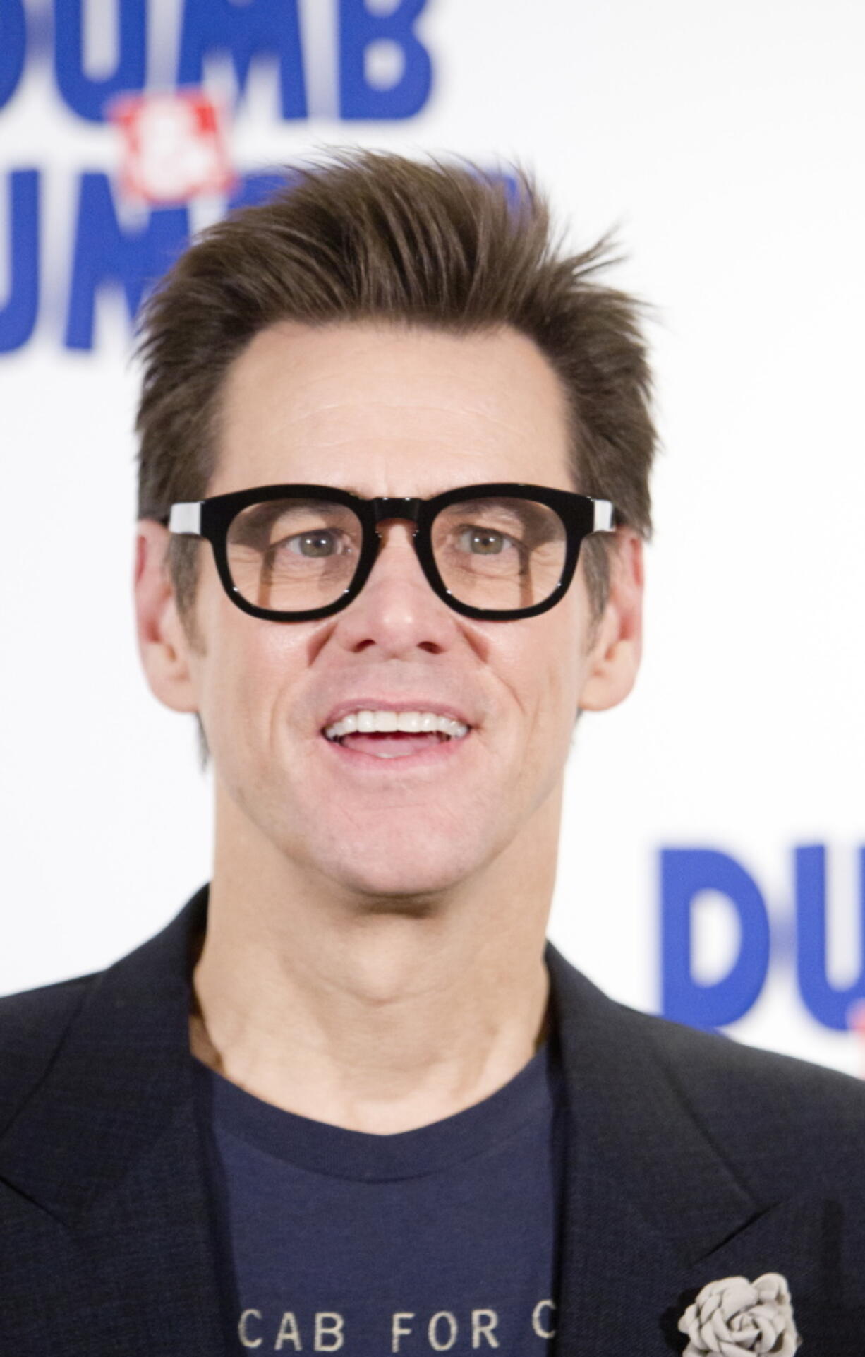 Jim Carrey poses for photographers Nov. 20, 2014, for the &quot;Dumb and Dumber To&quot; photo call in Paris, France. Carrey says a wrongful death lawsuit filed by the husband of his ex-girlfriend is a heartless attempt to exploit him. Mark Burton sued Carrey in Los Angeles Superior Court on Monday, accusing the actor of providing the prescription drugs Cathriona White used to overdose in September 2015. The wrongful death lawsuit contends Carrey improperly obtained prescriptions for Ambien and the powerful opioid oxycodone under the alias Arthur King.