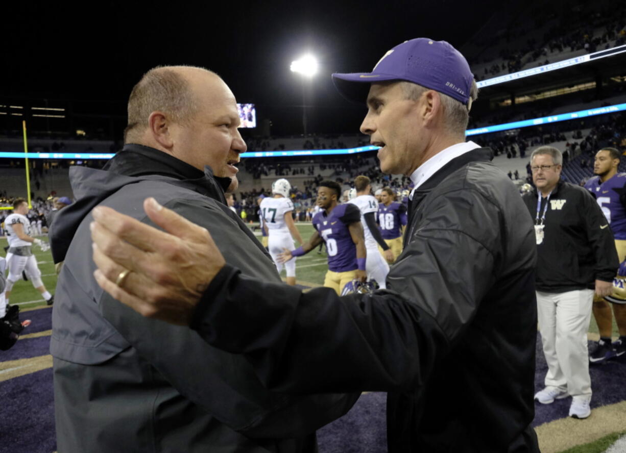 Portland State Vikings head coach Bruce Barnum, left, greets Washington Huskies head coach Chris Petersen, right, after an NCAA college football game, Saturday, Sept. 17, 2016, in Seattle. Washington won 41-3.