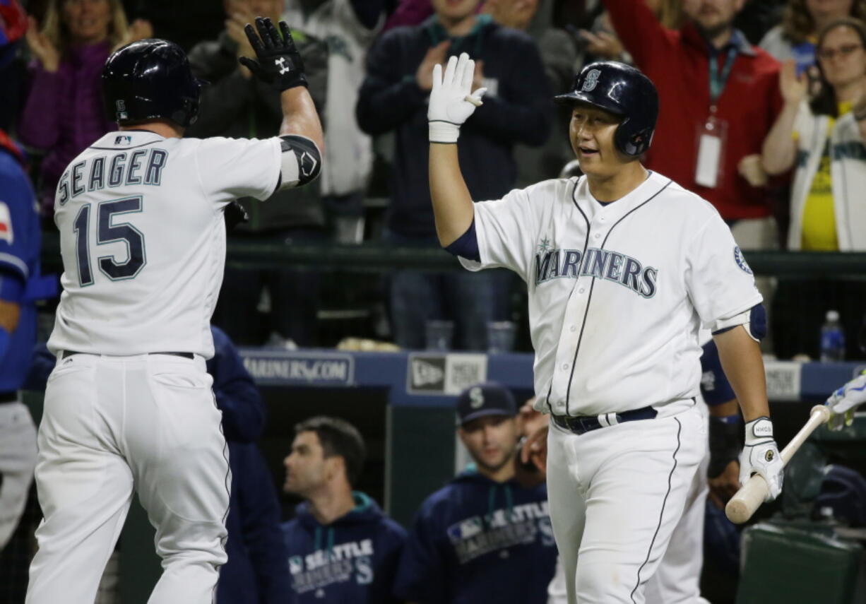 Seattle&#039;s Kyle Seager (15) is greeted by Dae-Ho Lee, right, after Seager hit a two-run home run during the seventh inning Thursday. (Ted S.